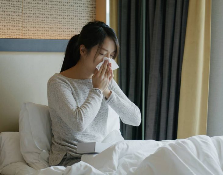 Woman get sick and sneeze on bed