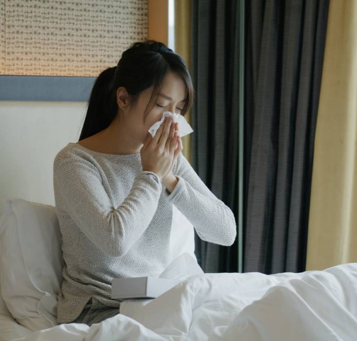 Woman get sick and sneeze on bed