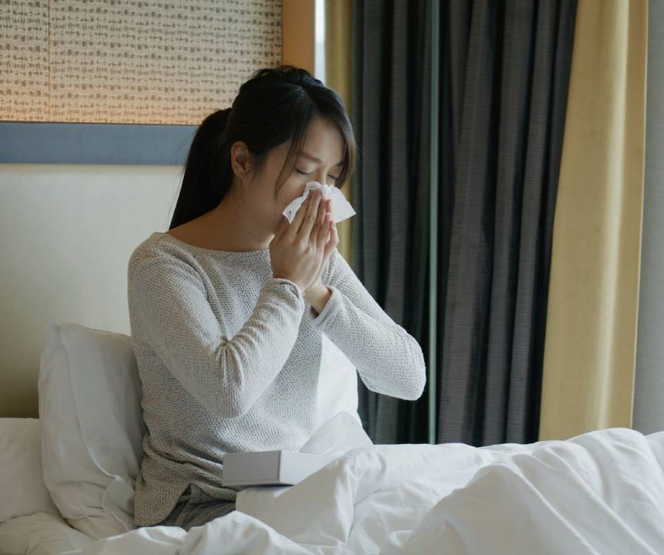 Woman get sick and sneeze on bed