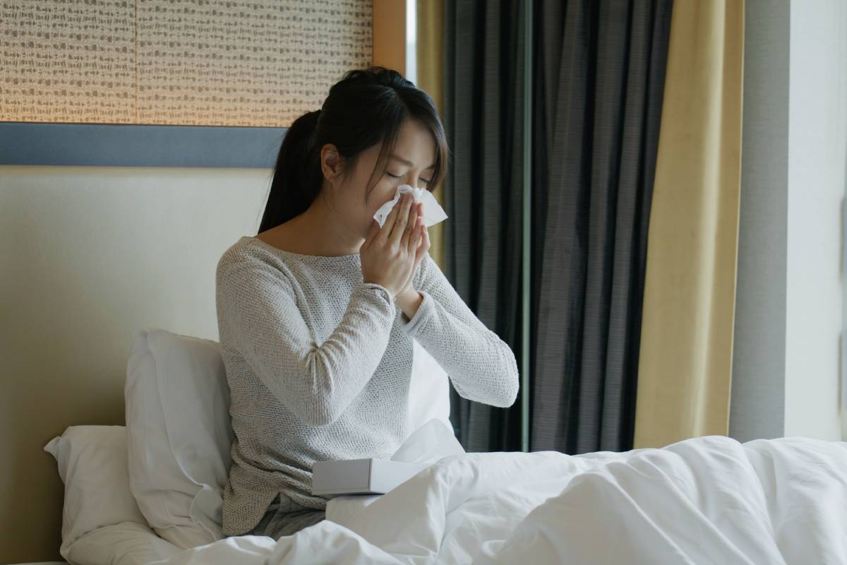 Woman get sick and sneeze on bed
